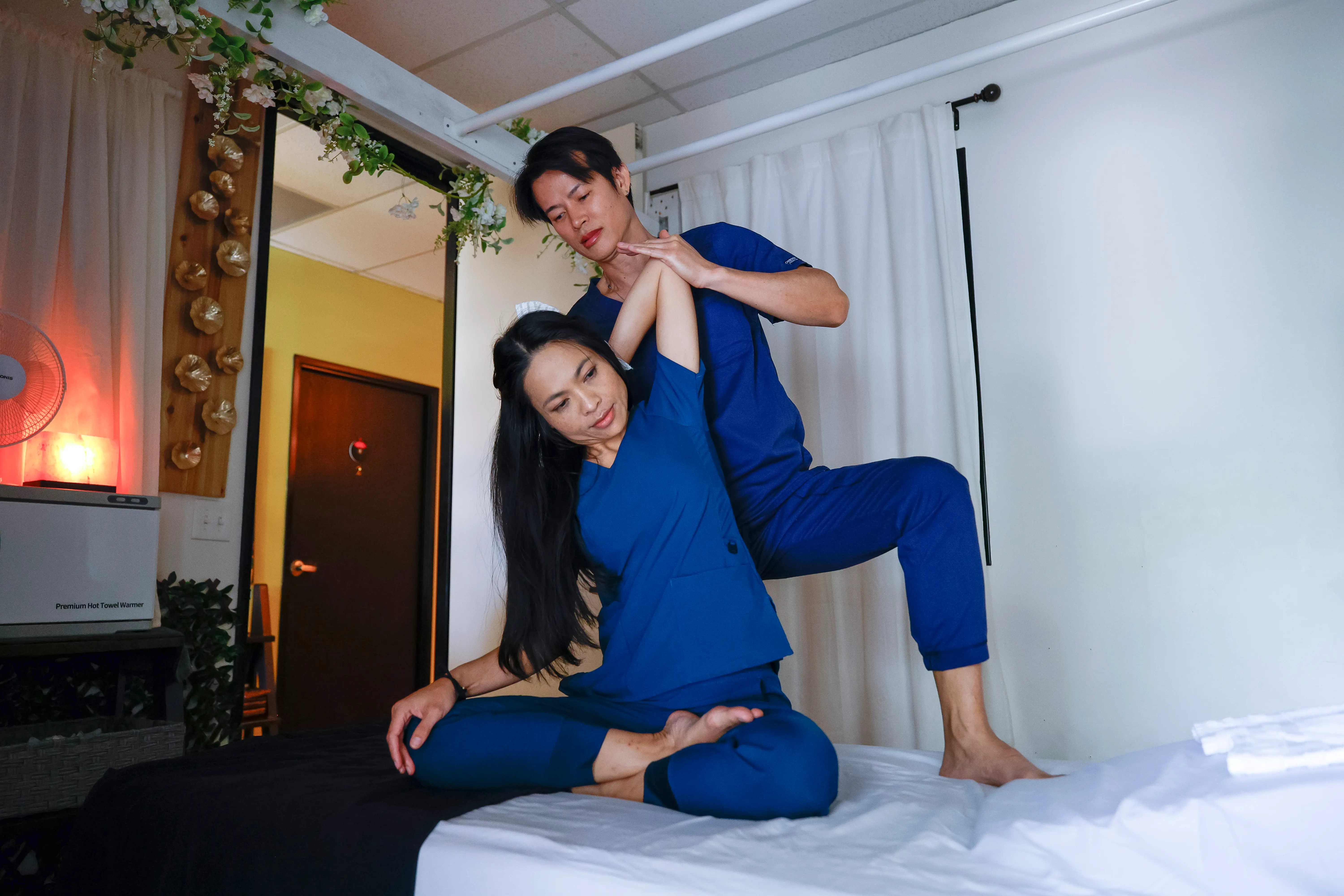 Maya therapist performing traditional Thai massage techniques